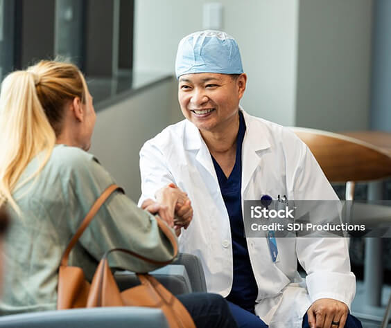 Photo of a doctor shaking hands with a patient