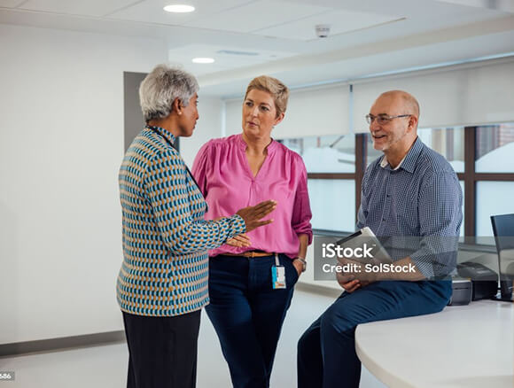 Group of people talking in a clinical setting